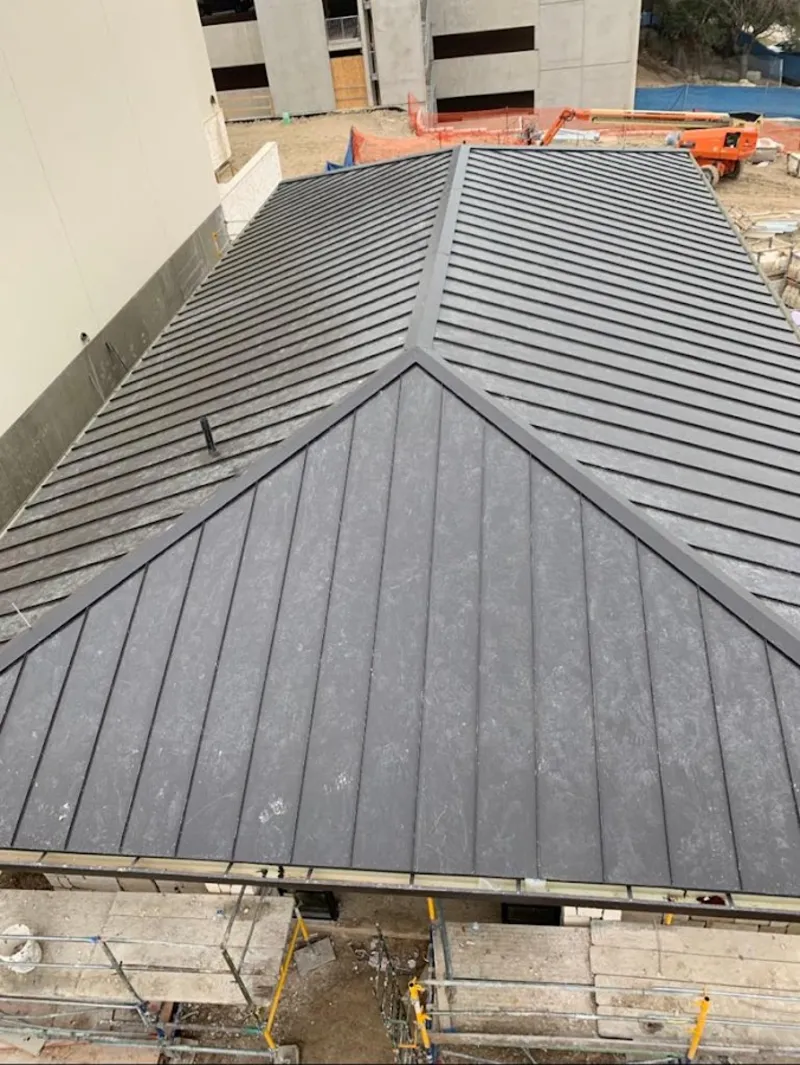 Commercial metal roof construction with crane equipment in Chalmette
